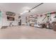 A well lit garage featuring an epoxy sealed floor and lots of storage at 766 E Taylor Trl, San Tan Valley, AZ 85143