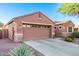 Exterior view of a single-story home showcasing a two-car garage and desert landscaping at 766 E Taylor Trl, San Tan Valley, AZ 85143