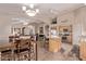 Bright, open kitchen featuring an island, stainless appliances, and seamless flow into the dining and living spaces at 766 E Taylor Trl, San Tan Valley, AZ 85143