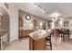 Well-lit kitchen showcases granite countertops, stainless steel appliances, and an adjacent dining area with outdoor access at 766 E Taylor Trl, San Tan Valley, AZ 85143