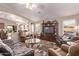 Open concept living room with stylish furniture, large windows, and an entertainment center at 766 E Taylor Trl, San Tan Valley, AZ 85143