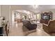 Spacious living room with an archway, tile flooring, and access to the dining room at 766 E Taylor Trl, San Tan Valley, AZ 85143