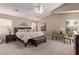 Relaxing main bedroom featuring a ceiling fan, plush carpeting, and neutral paint tones at 766 E Taylor Trl, San Tan Valley, AZ 85143