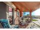 Relax on the covered patio overlooking the pool, ideal for entertaining or enjoying quiet moments outdoors at 766 E Taylor Trl, San Tan Valley, AZ 85143