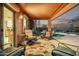 Relaxing covered patio with comfortable seating, an outdoor dining area, and views of the pool and well-manicured yard at 766 E Taylor Trl, San Tan Valley, AZ 85143