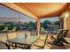 Spacious covered patio featuring ample seating, a dining area, and a serene view of the landscaped backyard, perfect for entertaining at 766 E Taylor Trl, San Tan Valley, AZ 85143