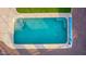 This aerial view shows a sparkling backyard pool with a built-in hot tub, creating a refreshing and inviting oasis at 766 E Taylor Trl, San Tan Valley, AZ 85143
