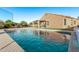 Backyard with pool, covered patio, and sports netting at 766 E Taylor Trl, San Tan Valley, AZ 85143