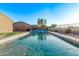 Backyard pool view with surrounding landscaping and a fence at 766 E Taylor Trl, San Tan Valley, AZ 85143