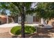This backyard offers an inviting space with artificial grass, a fire pit, and a covered patio, perfect for outdoor living at 81 E Rock Wren Dr, San Tan Valley, AZ 85143