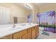 This bathroom has a double sink vanity and a shower/tub with colorful curtains at 81 E Rock Wren Dr, San Tan Valley, AZ 85143