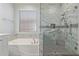 This bathroom has a sleek shower and a tub, plus a window for natural light at 81 E Rock Wren Dr, San Tan Valley, AZ 85143