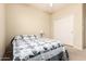 Bright bedroom featuring neutral walls, white trim, and a bed with blue and white comforter at 81 E Rock Wren Dr, San Tan Valley, AZ 85143