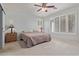 This bedroom has neutral paint, carpet, and bedding, plus a window and two lamps at 81 E Rock Wren Dr, San Tan Valley, AZ 85143