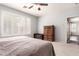 Bedroom with a ceiling fan and white shutters over the windows at 81 E Rock Wren Dr, San Tan Valley, AZ 85143