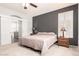Bedroom with a gray accent wall, and sliding doors to the bathroom at 81 E Rock Wren Dr, San Tan Valley, AZ 85143