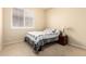A bedroom with light carpet and a single bed with a patterned comforter at 81 E Rock Wren Dr, San Tan Valley, AZ 85143