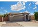 Exterior elevation featuring the home's neutral stucco, well-maintained yard, and long driveway at 81 E Rock Wren Dr, San Tan Valley, AZ 85143