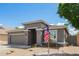 Charming single story home with gray stucco, tan roof and an American flag at 81 E Rock Wren Dr, San Tan Valley, AZ 85143