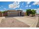 Home exterior featuring a well-maintained yard, long driveway, and neutral stucco at 81 E Rock Wren Dr, San Tan Valley, AZ 85143
