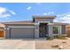 Inviting single-story home with a desert landscape, a two-car garage, and a welcoming front entrance at 81 E Rock Wren Dr, San Tan Valley, AZ 85143
