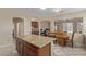 A modern kitchen features granite countertops, an island and stylish tile flooring at 81 E Rock Wren Dr, San Tan Valley, AZ 85143