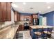 Well-equipped kitchen featuring stainless steel appliances, granite countertops, and a kitchen island with seating at 81 E Rock Wren Dr, San Tan Valley, AZ 85143