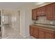 Kitchen featuring wood cabinets, tile backsplash, granite countertops, and stainless steel appliances at 81 E Rock Wren Dr, San Tan Valley, AZ 85143