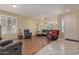 Spacious living room boasts beautiful wood floors, comfortable seating, and tons of natural light at 81 E Rock Wren Dr, San Tan Valley, AZ 85143