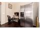 A small office area featuring a stainless steel refrigerator with a dark hardwood floor at 81 E Rock Wren Dr, San Tan Valley, AZ 85143