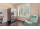 This office features a comfortable chair and plenty of light, making it an inviting space to work or relax at 81 E Rock Wren Dr, San Tan Valley, AZ 85143