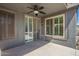 Covered patio area with a ceiling fan, sliding glass door, and ample space for outdoor living at 81 E Rock Wren Dr, San Tan Valley, AZ 85143