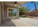 Covered patio area overlooking backyard with an outdoor ceiling fan and sliding glass door at 81 E Rock Wren Dr, San Tan Valley, AZ 85143