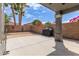 This covered patio features desert landscaping and a built-in bbq, providing an ideal space for outdoor entertaining at 81 E Rock Wren Dr, San Tan Valley, AZ 85143