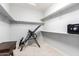 A walk-in closet with shelving, carpeted floors, and a security safe at 81 E Rock Wren Dr, San Tan Valley, AZ 85143