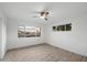 A bedroom featuring light hardwood floors, updated lighting, and large windows offering neighborhood views at 8228 E Oak St, Scottsdale, AZ 85257