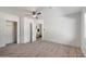 Bright bedroom with a ceiling fan and light wood-look flooring and an ensuite entrance at 8228 E Oak St, Scottsdale, AZ 85257