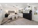 A bright bedroom featuring a large window, neutral colored furniture, and light hardwood floors at 8228 E Oak St, Scottsdale, AZ 85257