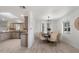 Elegant dining area with a stylish chandelier, neutral decor, and seamless flow into the kitchen at 8228 E Oak St, Scottsdale, AZ 85257