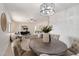 Open-concept dining area with comfortable seating, a stylish chandelier, and a view into the living room at 8228 E Oak St, Scottsdale, AZ 85257