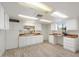 A kitchen with light hardwood floors, white cabinets, butcher block countertops and natural light at 8228 E Oak St, Scottsdale, AZ 85257
