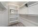 A walk-in closet with painted shelving and light hardwood floors at 8228 E Oak St, Scottsdale, AZ 85257