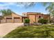 Charming single-story home featuring a well-manicured front yard, terracotta roof, and two-car garage at 8512 E Gilded Perch Dr, Scottsdale, AZ 85255