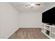 Minimalist bedroom design with carpeted floor, ceiling fan, and modern white entertainment center at 854 S San Marcos Dr # A12, Apache Junction, AZ 85120