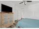 Cozy bedroom featuring ample closet space, ceiling fan, and a window with natural light at 854 S San Marcos Dr # A12, Apache Junction, AZ 85120