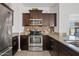 Close-up of the kitchen with stainless steel appliances, modern fixtures, and granite countertops at 854 S San Marcos Dr # A12, Apache Junction, AZ 85120