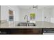Modern kitchen sink with granite countertops, stainless steel appliances, and bright lighting at 854 S San Marcos Dr # A12, Apache Junction, AZ 85120
