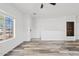 Open living space with hard surface floors and ample natural light from the large windows at 854 S San Marcos Dr # A12, Apache Junction, AZ 85120