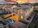 Aerial shot displays backyard with pool, pavers, turf, outdoor lighting, and solar panels on the roof at 880 E Wimpole Ave, Gilbert, AZ 85297