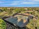 Aerial view of tennis courts within a community surrounded by homes and lush landscaping, offering recreational amenities at 880 E Wimpole Ave, Gilbert, AZ 85297